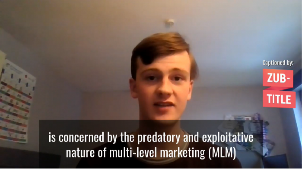 Image of Jack Bell MSYP with short brown hair and a red t-shirt giving a speech over Zoom. The subtitles read 'Is concerned by the predatory and exploitative nature of multi-level marketing (MLM) schemes