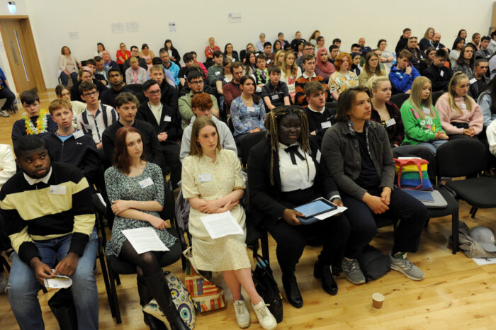MSYPs sitting in the hall, listening to speakers at SYP77