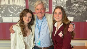 Beau and Daisy standing on either side of Bragi, a member of the UN Committee on the Rights of the Child.