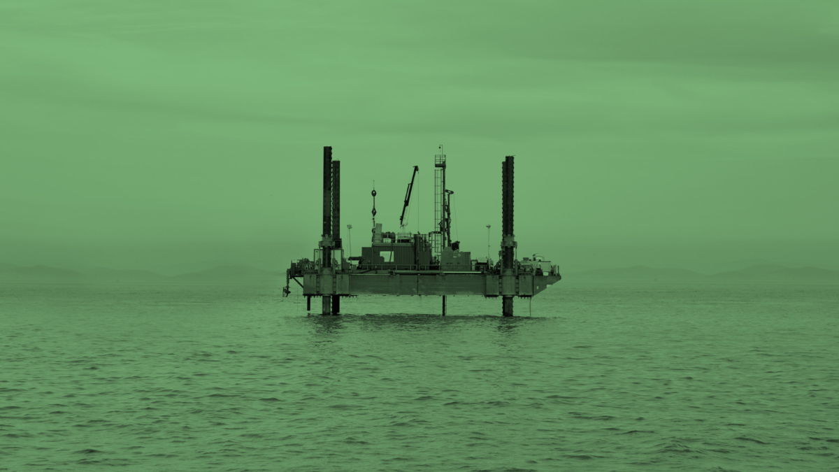 Image of an oil rig out at sea with a green tint overlaid.