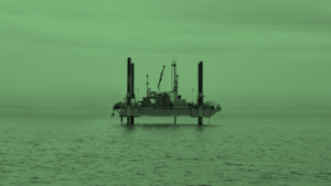 Image of an oil rig out at sea with a green tint overlaid.
