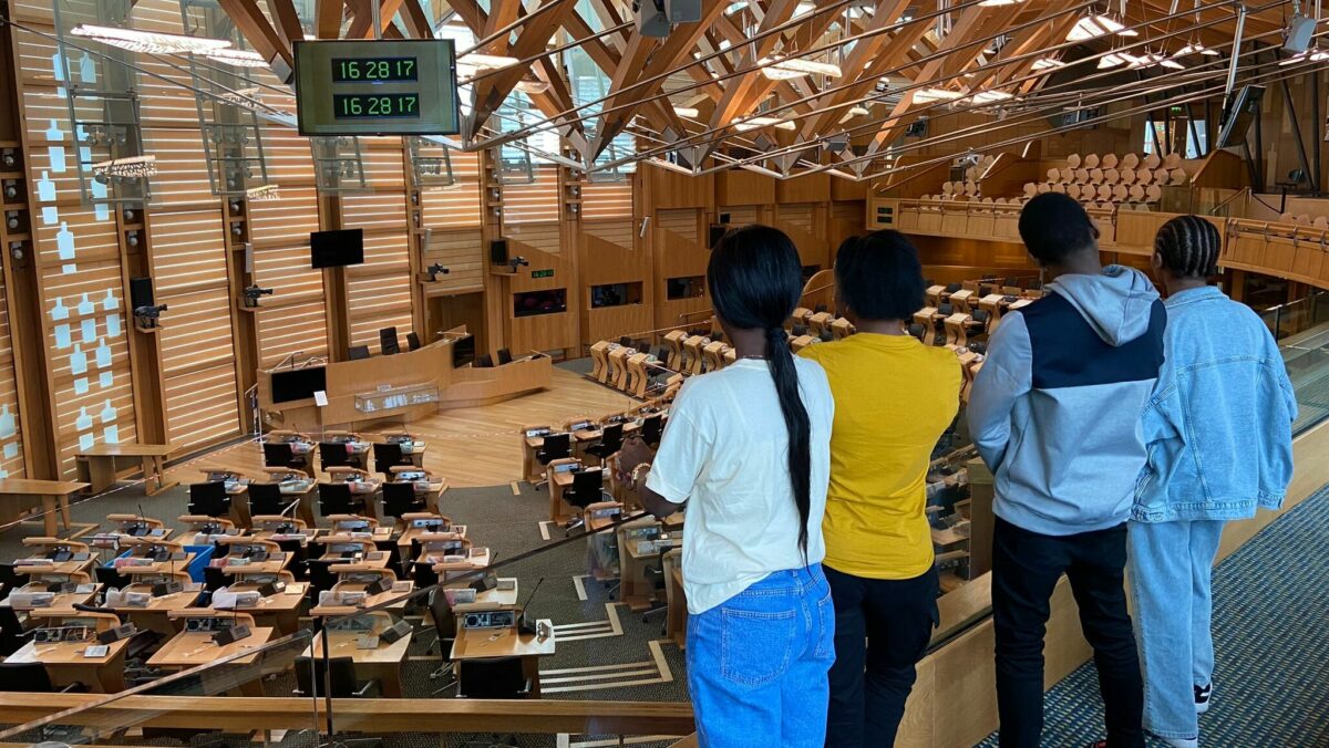 Young people from the Guardianship Scotland project in the Scottish Parliament chamber