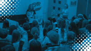 Image of an MSYP sitting at a table talking to a friend. Blue tint overlaid with white polka dots in corners.