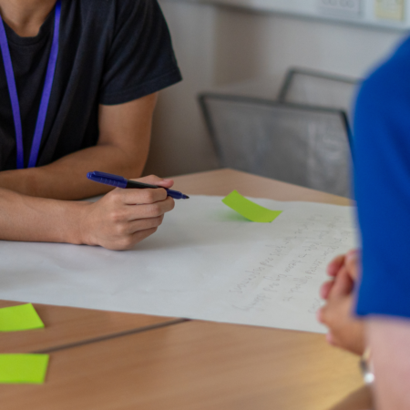MSYPs at a table writing on paper.