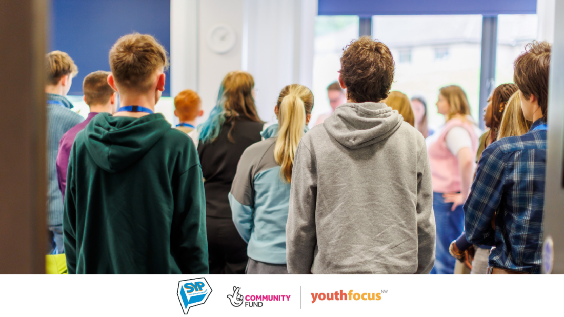 A group of MSYPs standing next to each other in a room. MSYPs are giving their back to the camera, so their faces can't be seen.